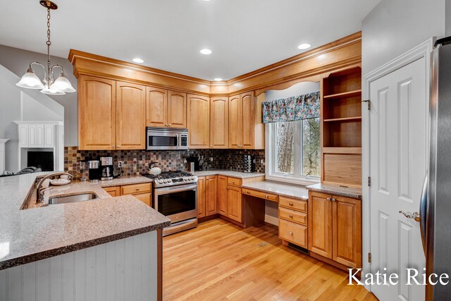 5575 Beechmont Rd, Whitehall, MI 49461 - kitchen featuring a sink, hanging light fixtures, light wood-style floors, backsplash, and appliances with stainless steel finishes