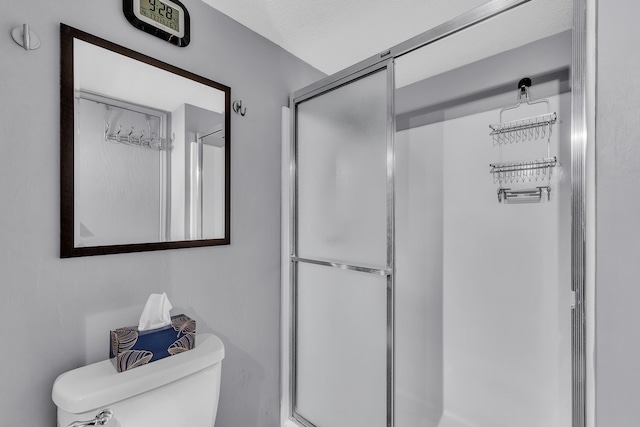 full bathroom with a shower stall and toilet