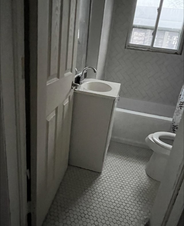 full bath with vanity, tile patterned flooring, and toilet