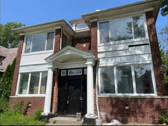 view of front of home featuring brick siding