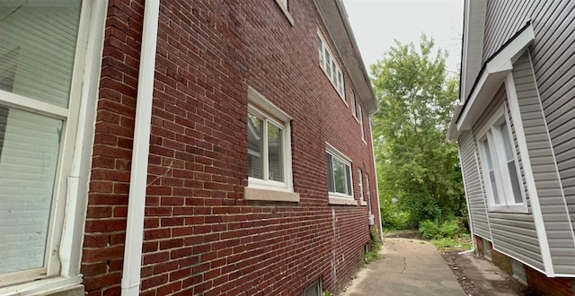 view of side of home with brick siding