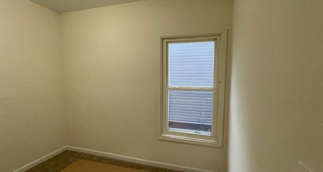 spare room featuring baseboards