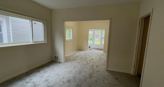 spare room with baseboards and carpet