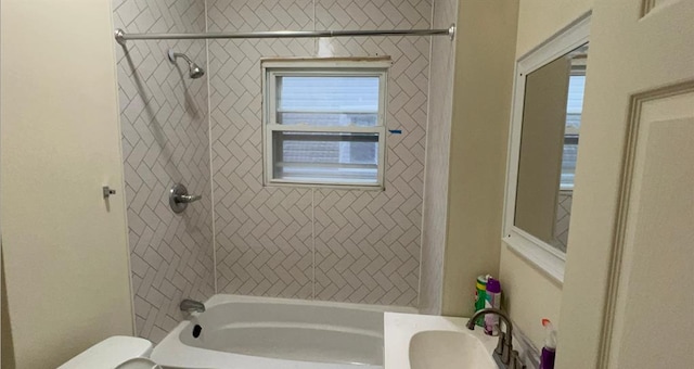bathroom featuring shower / bath combination, a sink, and toilet