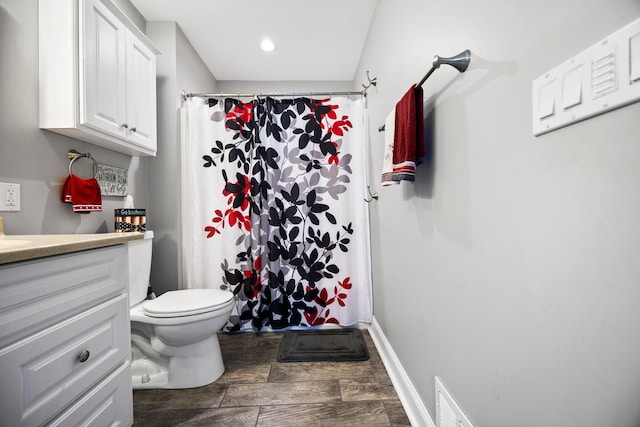 1219 Nokomis Dr, Gladwin, MI 48624 - full bath with wood finished floors, vanity, a shower with curtain, toilet, and visible vents