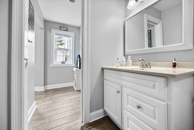 1219 Nokomis Dr, Gladwin, MI 48624 - bathroom with baseboards, vanity, and wood finished floors