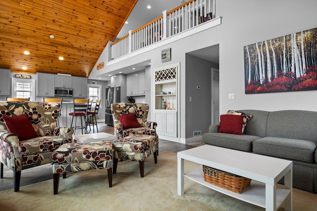 1219 Nokomis Dr, Gladwin, MI 48624 - living area with high vaulted ceiling, wooden ceiling, baseboards, and recessed lighting