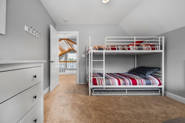 1219 Nokomis Dr, Gladwin, MI 48624 - bedroom with carpet floors, vaulted ceiling, and baseboards