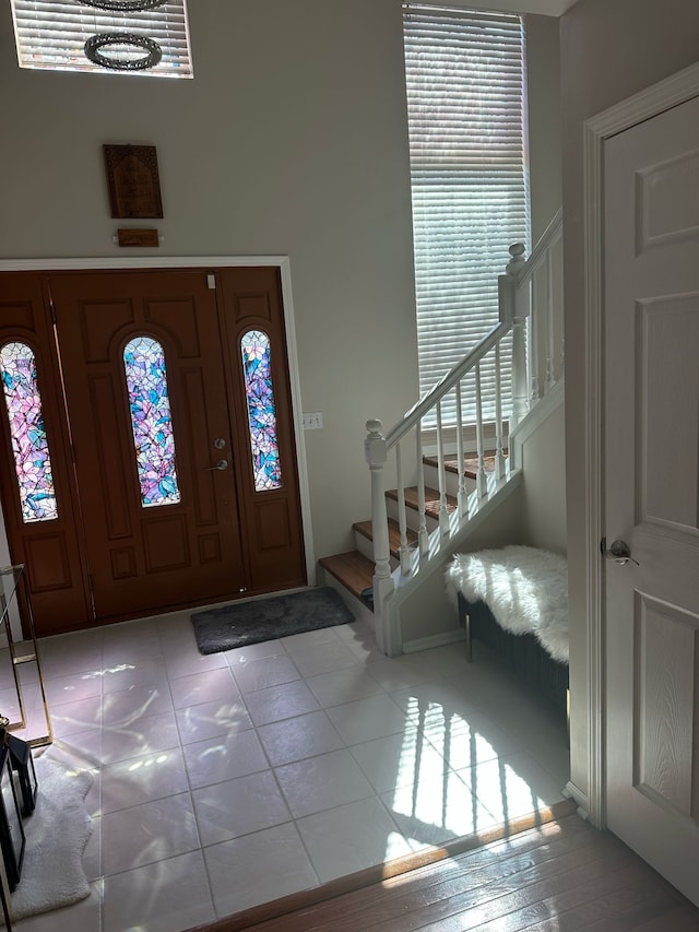 entryway with stairs and tile patterned floors