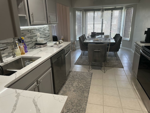 kitchen featuring dishwasher, range with electric stovetop, gray cabinets, a sink, and backsplash