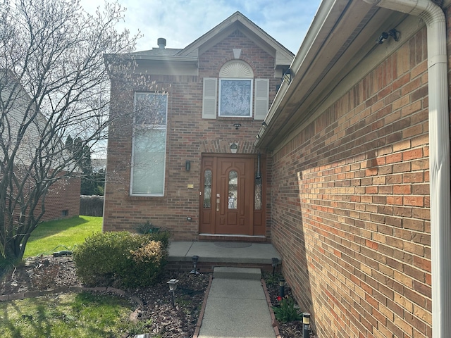 entrance to property with brick siding