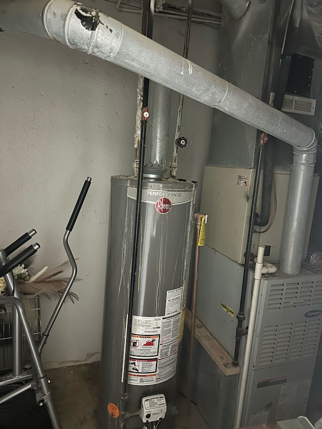 utility room with heating unit and gas water heater