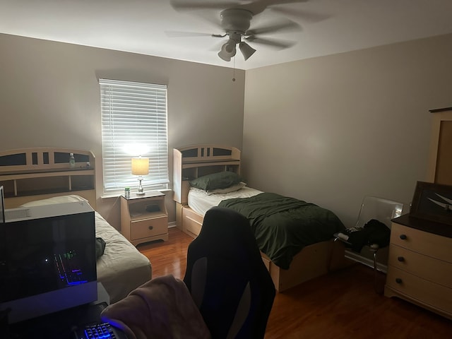 bedroom with wood finished floors and a ceiling fan