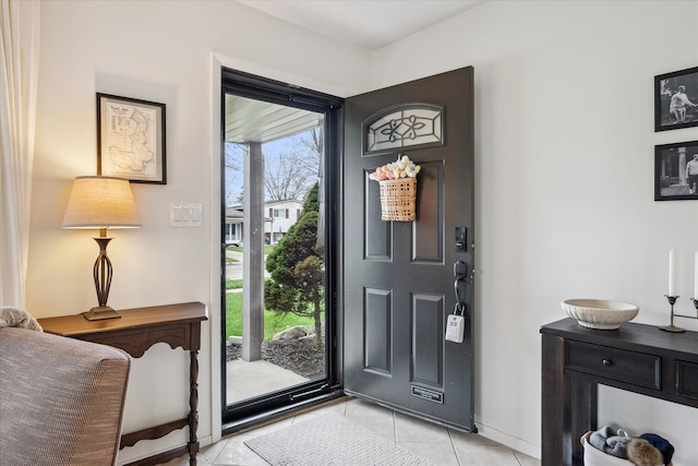 entrance foyer featuring baseboards and light tile patterned floors