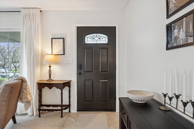 entrance foyer with a wealth of natural light and light tile patterned flooring