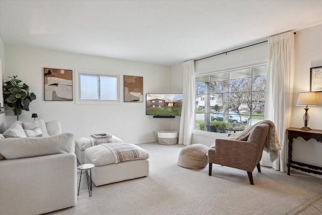 living room featuring carpet flooring and a healthy amount of sunlight