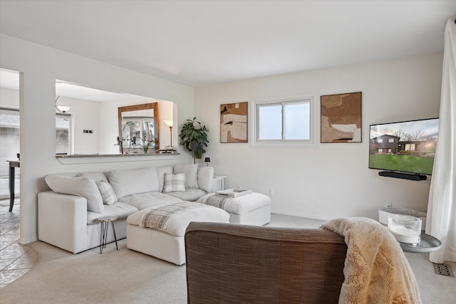 living area featuring light colored carpet and visible vents