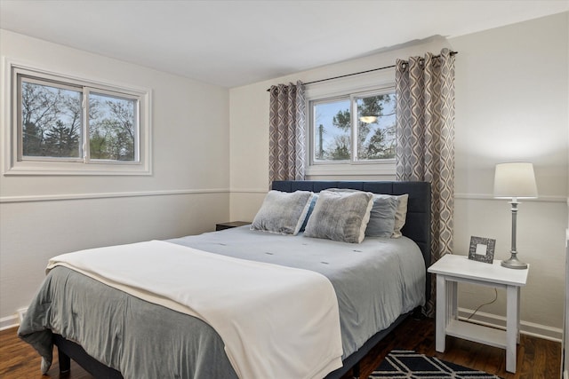 bedroom with baseboards and wood finished floors
