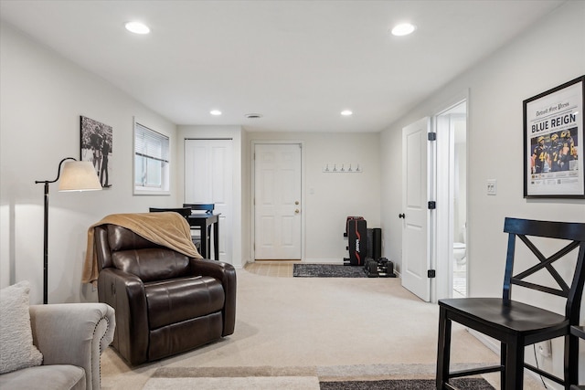 living area featuring recessed lighting, baseboards, and light carpet