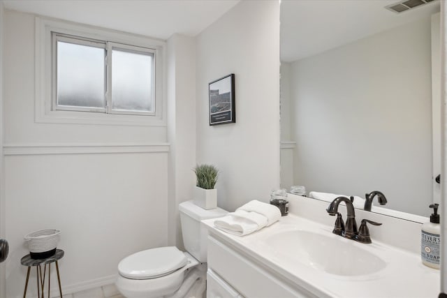 bathroom featuring visible vents, tile patterned flooring, vanity, and toilet