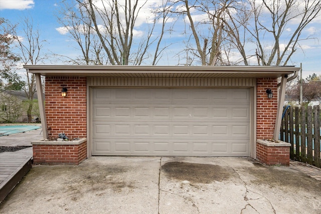 detached garage featuring fence