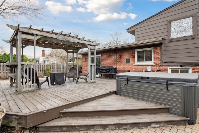 wooden terrace with a grill, a hot tub, and a pergola
