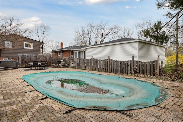 view of pool with a fenced in pool, a patio area, outdoor dining space, and fence