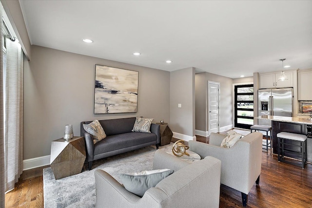 living area featuring baseboards, dark wood-type flooring, and recessed lighting