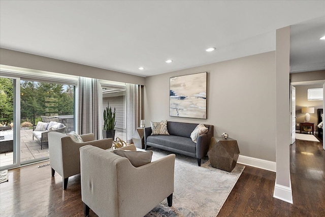 living area with baseboards, wood finished floors, and recessed lighting