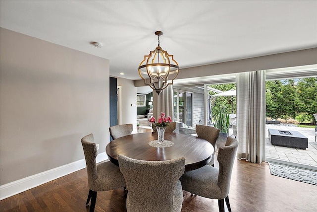 dining area with baseboards, a notable chandelier, wood finished floors, and recessed lighting