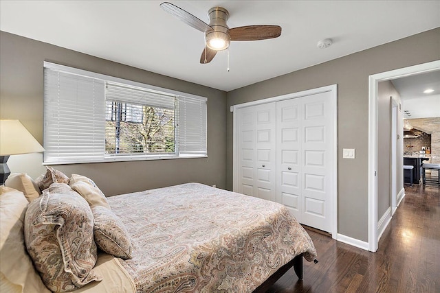 bedroom featuring baseboards, a ceiling fan, wood finished floors, and a closet