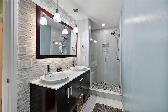 full bath featuring decorative backsplash, tile patterned floors, a sink, and a shower stall