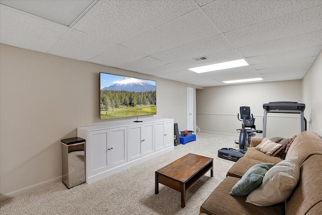 living room featuring baseboards, visible vents, carpet floors, and a drop ceiling