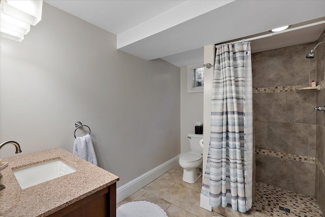 bathroom with vanity, toilet, tiled shower, and tile patterned floors