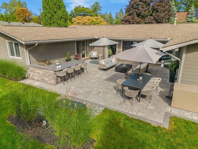 back of house featuring a patio area, a shingled roof, outdoor dining area, and an outdoor living space