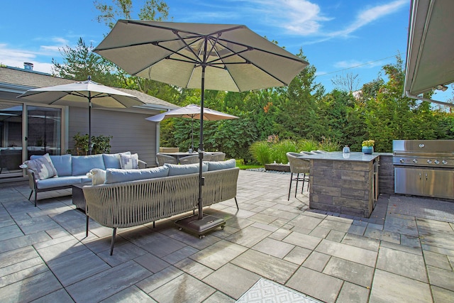 view of patio featuring area for grilling, outdoor lounge area, outdoor dry bar, and a grill