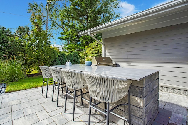view of patio / terrace with outdoor dry bar and area for grilling