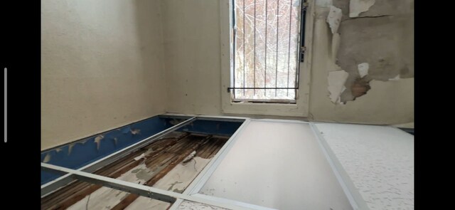 unfurnished room with wood finished floors
