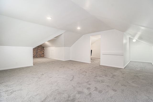 additional living space with recessed lighting, baseboards, vaulted ceiling, and carpet