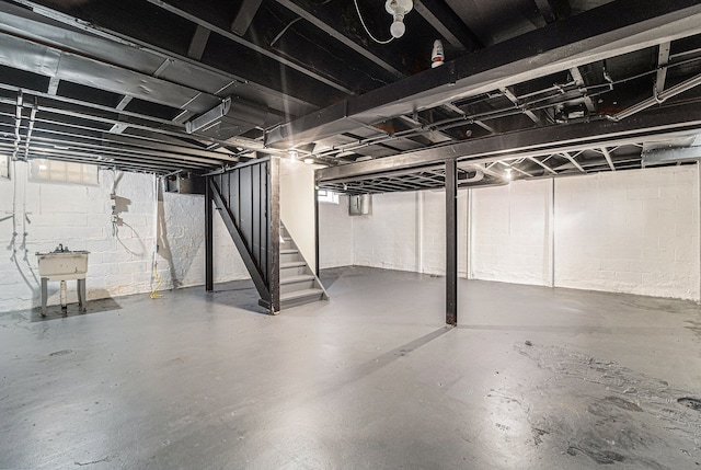 unfinished below grade area with a sink and stairway