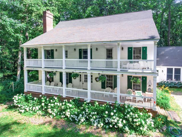 2457 Rocky Top Ln, Commerce Twp, MI 48382 - view of front of property featuring a balcony and a chimney
