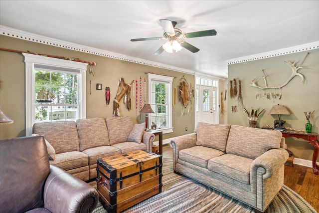2457 Rocky Top Ln, Commerce Twp, MI 48382 - living area with wood finished floors, a ceiling fan, ornamental molding, and baseboards