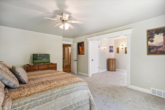 2457 Rocky Top Ln, Commerce Twp, MI 48382 - carpeted bedroom with baseboards and a ceiling fan