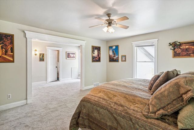 2457 Rocky Top Ln, Commerce Twp, MI 48382 - carpeted bedroom with baseboards and a ceiling fan