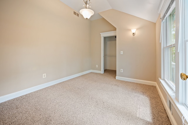2457 Rocky Top Ln, Commerce Twp, MI 48382 - empty room with vaulted ceiling, plenty of natural light, light colored carpet, and baseboards