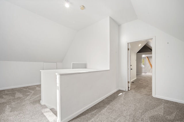 2457 Rocky Top Ln, Commerce Twp, MI 48382 - additional living space with carpet, lofted ceiling, and baseboards