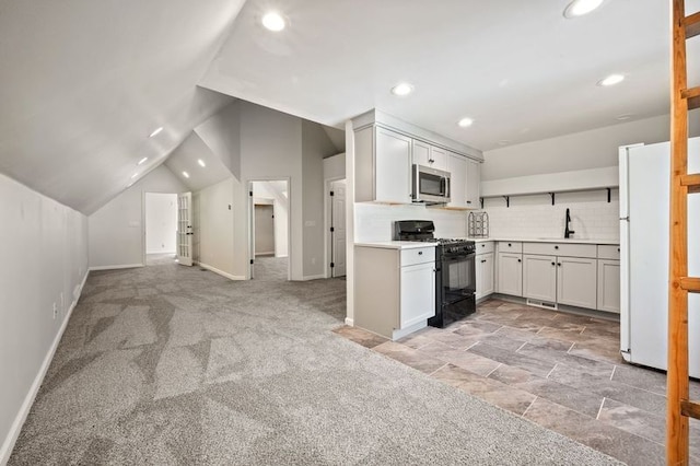 2457 Rocky Top Ln, Commerce Twp, MI 48382 - kitchen featuring black range with gas stovetop, stainless steel microwave, freestanding refrigerator, a sink, and baseboards