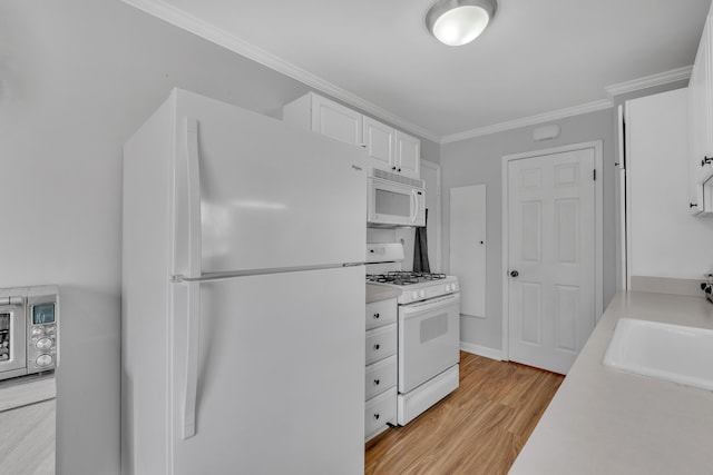 kitchen with light wood-style flooring, white cabinetry, white appliances, light countertops, and ornamental molding