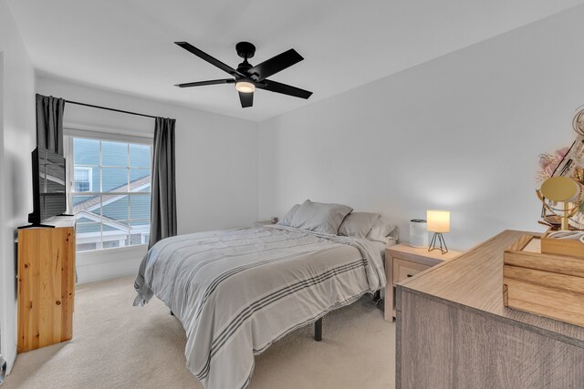 bedroom with light carpet and ceiling fan