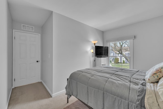 carpeted bedroom featuring baseboards and visible vents